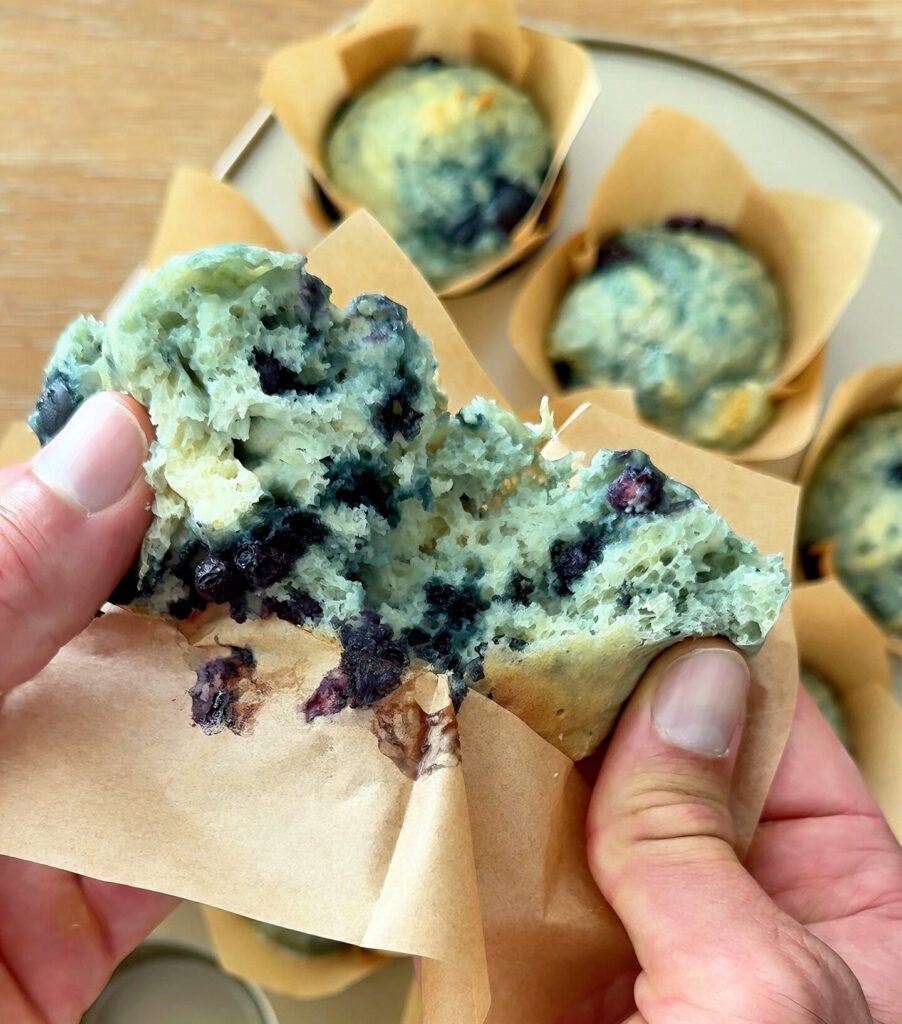 Cottage cheese blueberry muffins sliced open to show the soft interior and pockets of blueberries.