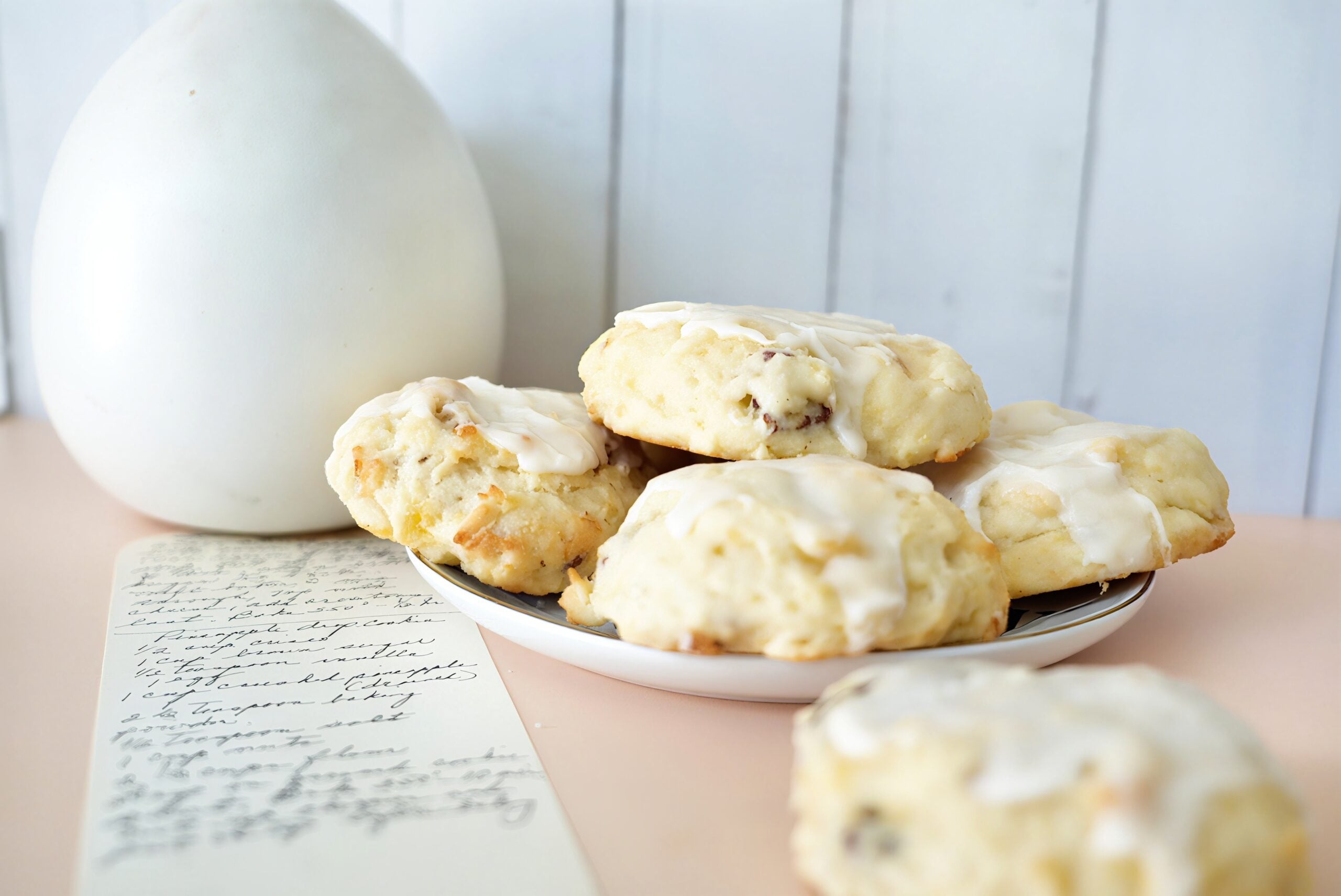 Close-up of a soft pineapple drop cookie with a golden top and visible bits of pineapple.