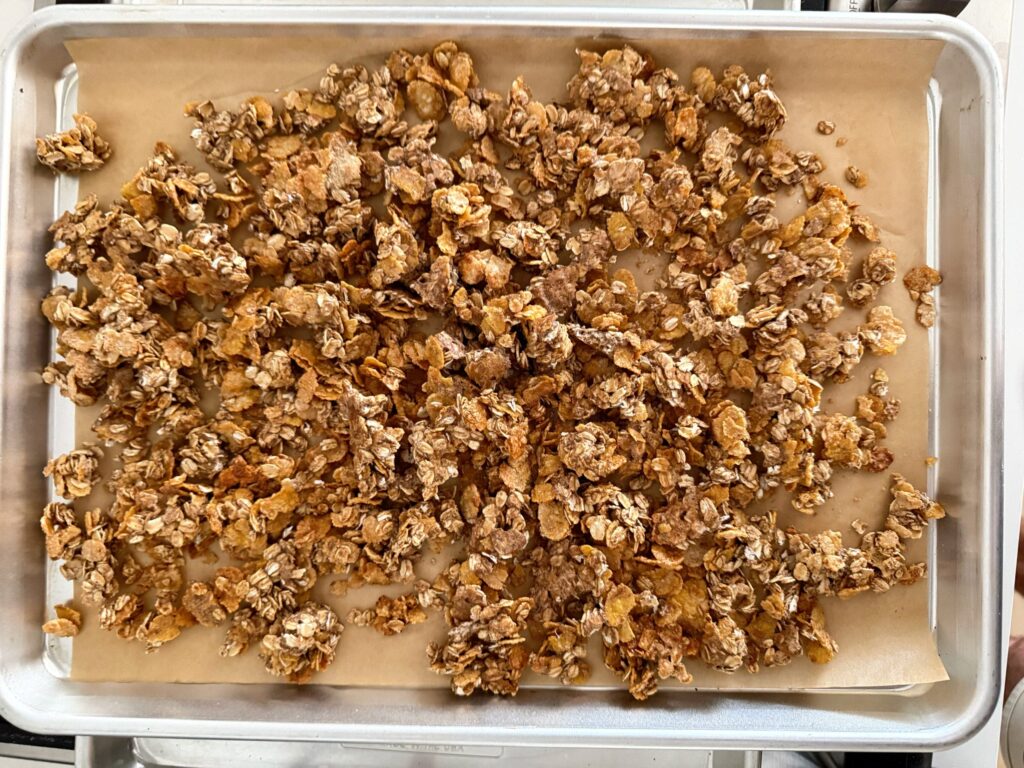 Protein granola spread across a sheet pan and baked until golden and crisp.