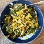 Crispy roasted Brussels sprouts served as a bite-sized appetizer with a light glaze and golden edges.