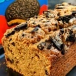 Moist high-protein Oreo loaf cake topped with creamy frosting and crushed Oreo pieces.