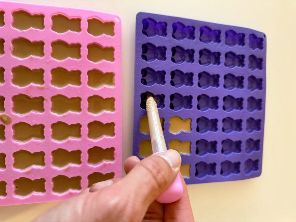 filling silicone gummy molds with mocha protein shake mixture