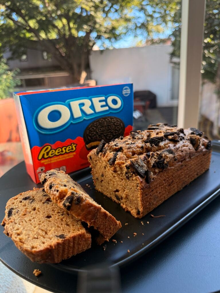 Close-up of a sliced high-protein Oreo loaf cake showing cookies-and-cream texture