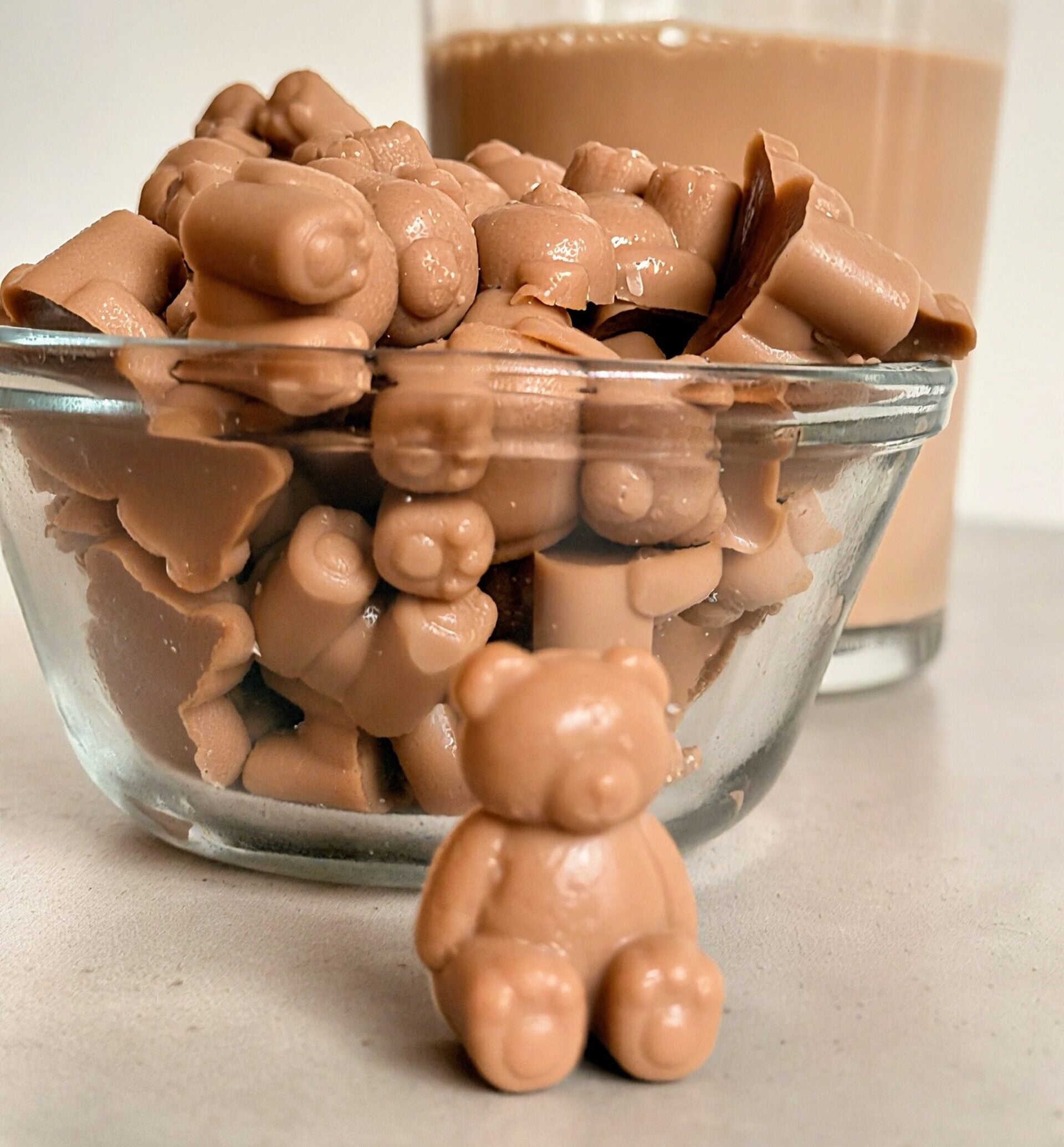 close-up bowl of homemade mocha protein gummies shaped like bears