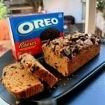 Moist high-protein Oreo loaf cake topped with creamy frosting and crushed Oreo pieces.