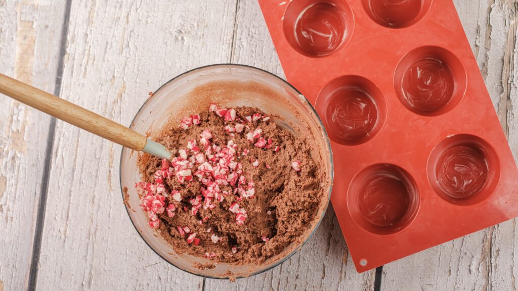 mixing peppermint cottage cheese muffin batter with crushed candy canes