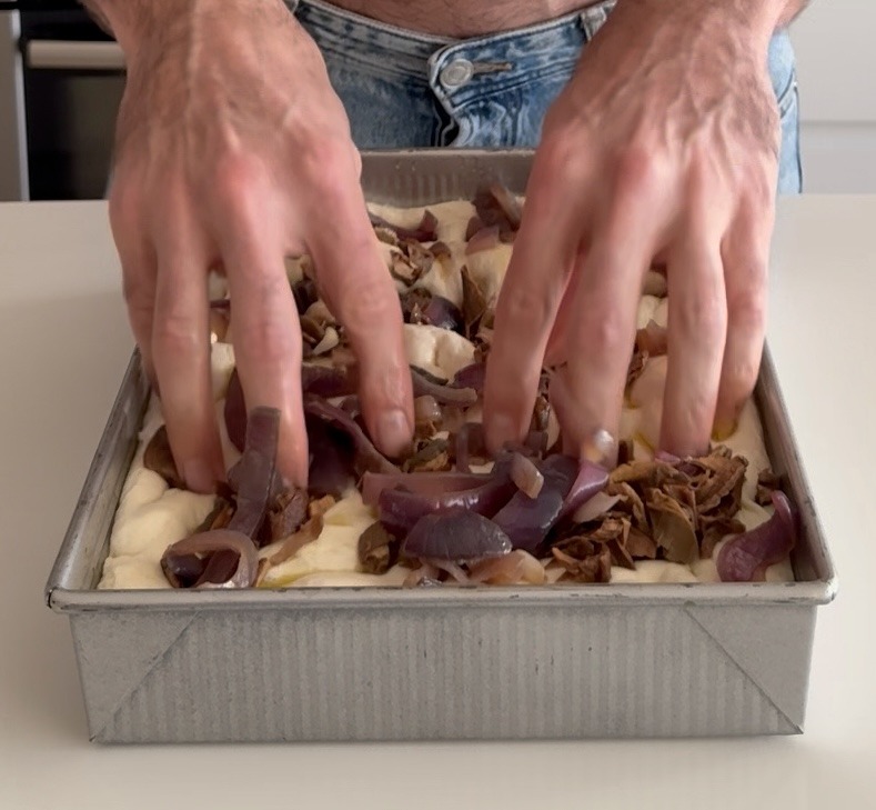 Pressing Toppings into Focaccia Dough