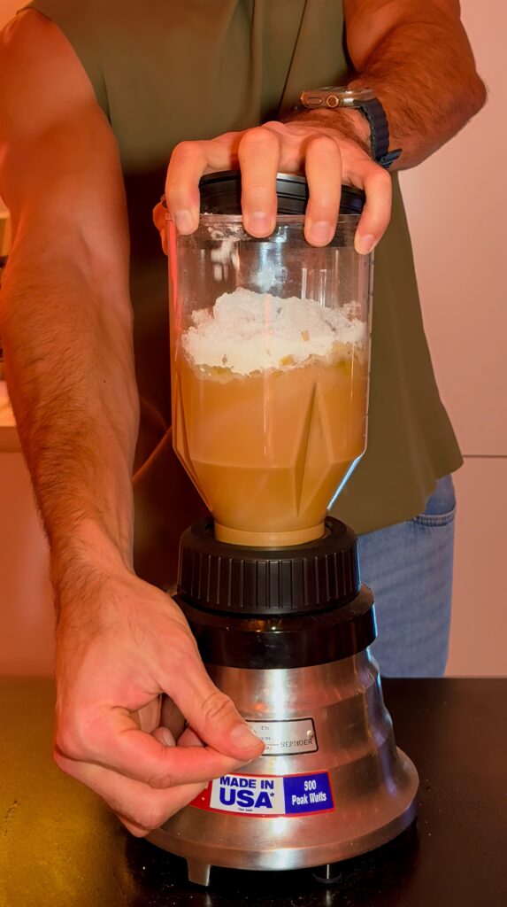 Protein shake loaf ingredients in a blender cup before mixing.