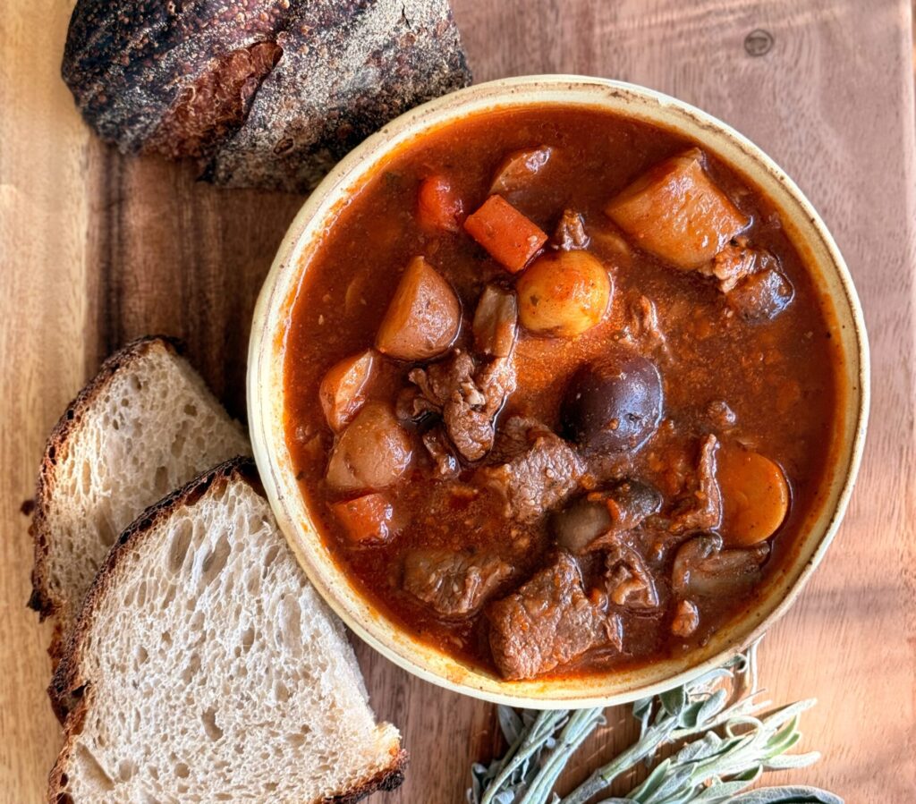 Hearty beef and lamb stew with potatoes, carrots, and mushrooms served in a bowl