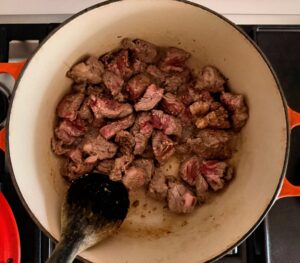 Beef and lamb browning in a Dutch oven