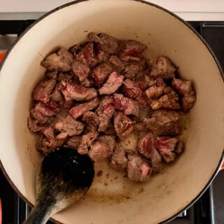 Beef and lamb browning in a Dutch oven
