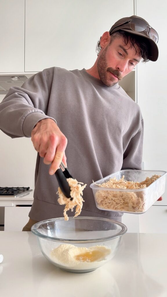 Mixing buffalo chicken into cornbread waffle batter