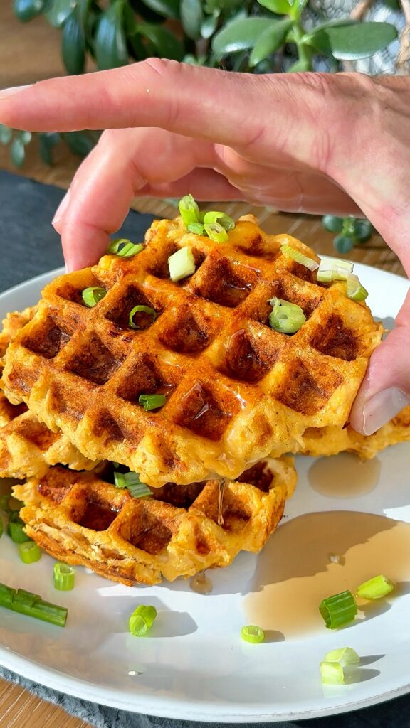 Stack of buffalo chicken cornbread waffles served on a plate