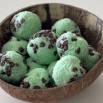 Extreme close-up shot showing the soft, edible texture and visible mini chocolate chips in the mint-flavored protein cookie dough.