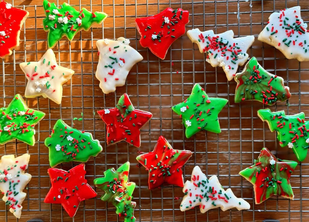 Decorated vintage sour cream cut out cookies on cooling rack
