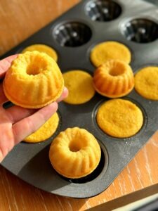 Baked mini Bundt cakes sitting inside the baking tray/molds, ready to be cooled and removed.