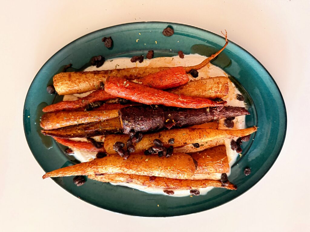 Overhead shot of harissa maple glazed carrots with raisins