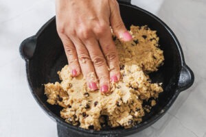 Pressing cookie dough into skillet