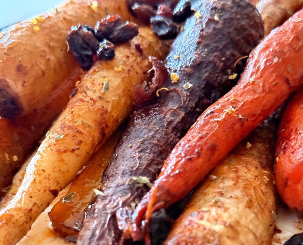 Extreme close-up of roasted carrots with maple harissa glaze
