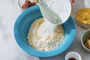 Adding flour to cookie dough bowl