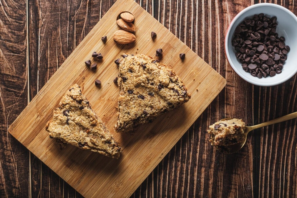 Skillet chocolate chip cookie sliced on wooden board