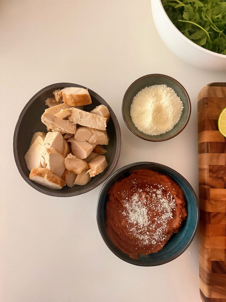 Assembled Mexican potato bowl with chicken, potatoes, cheese, and herbs