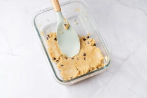 Smoothed gluten-free protein blondie batter in glass dish