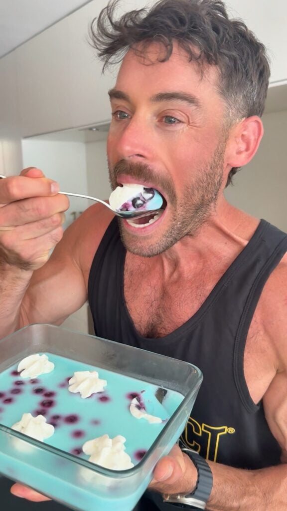 Spoonful of blue raspberry protein fluff with whipped topping