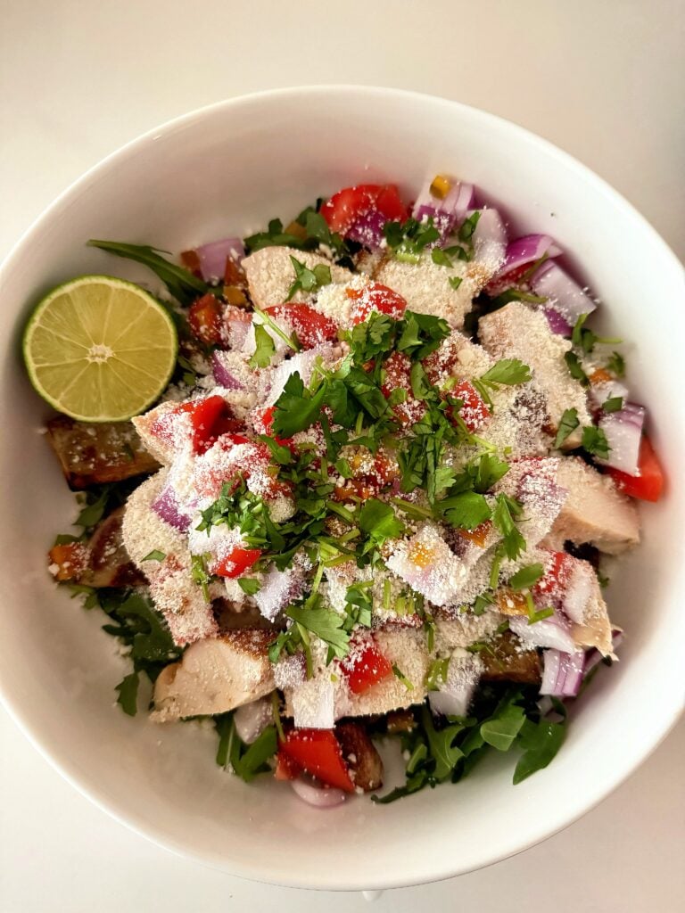 High protein Mexican potato bowl with chicken, potatoes, cilantro, onion, and cotija cheese