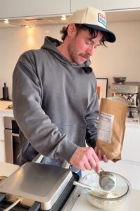 making high protein blueberry waffle batter in kitchen