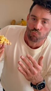 Man taking a bite of high protein egg salad