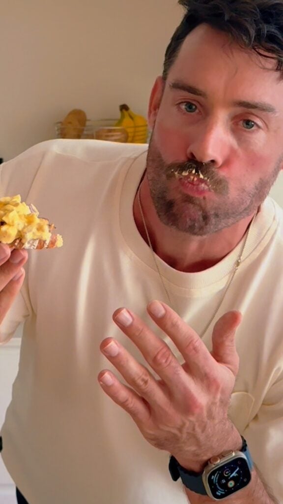 Man taking a bite of high protein egg salad