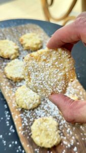 Hands holding pineapple cookie to show soft and tender texture