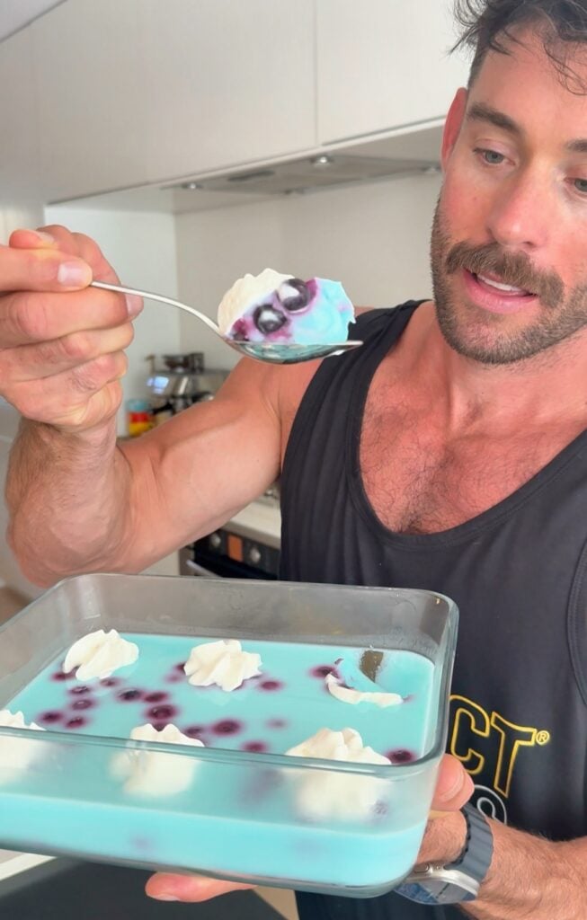 Starburst blue raspberry protein fluff topped with whipped cream and berries