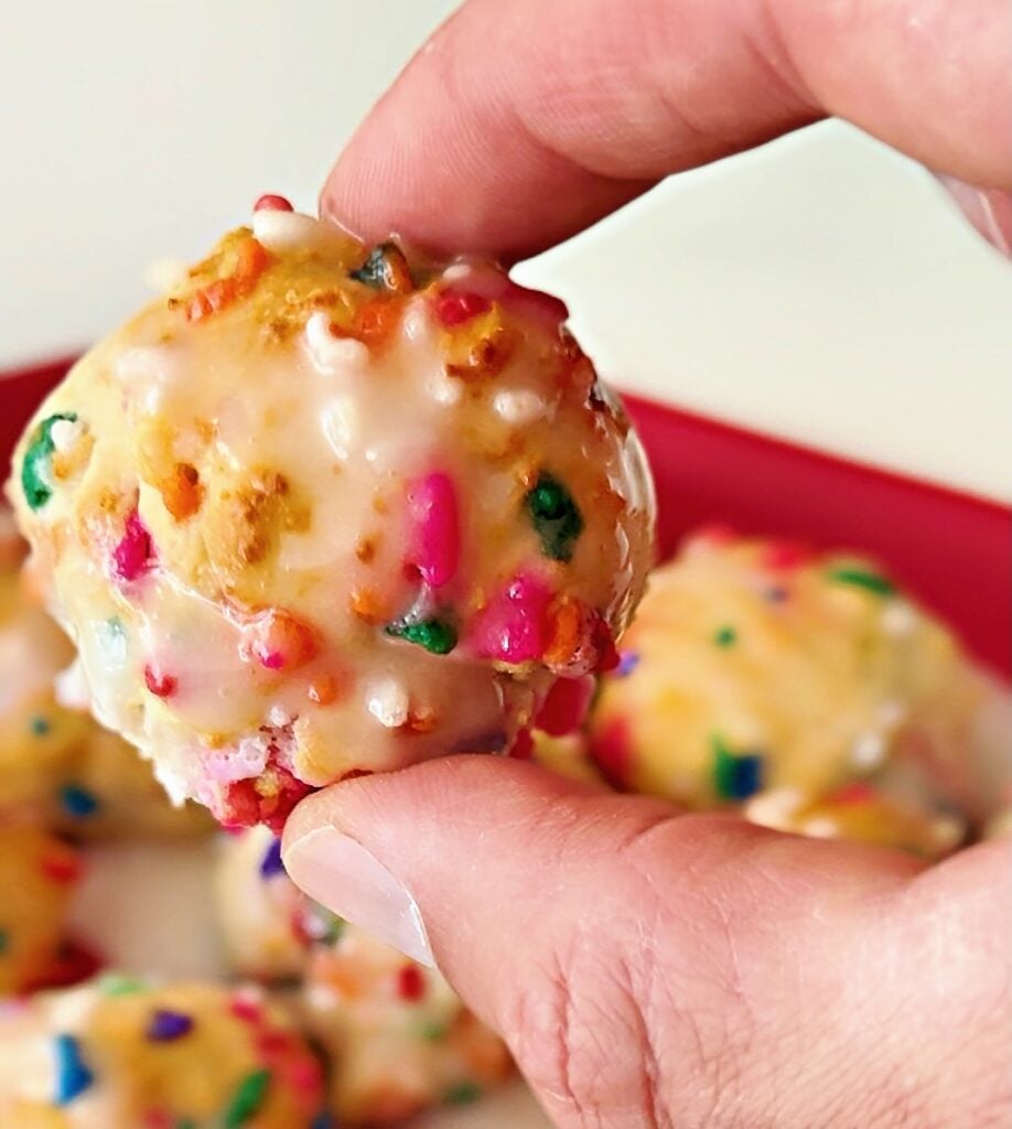Close-up of birthday cake protein donut holes with a fluffy interior