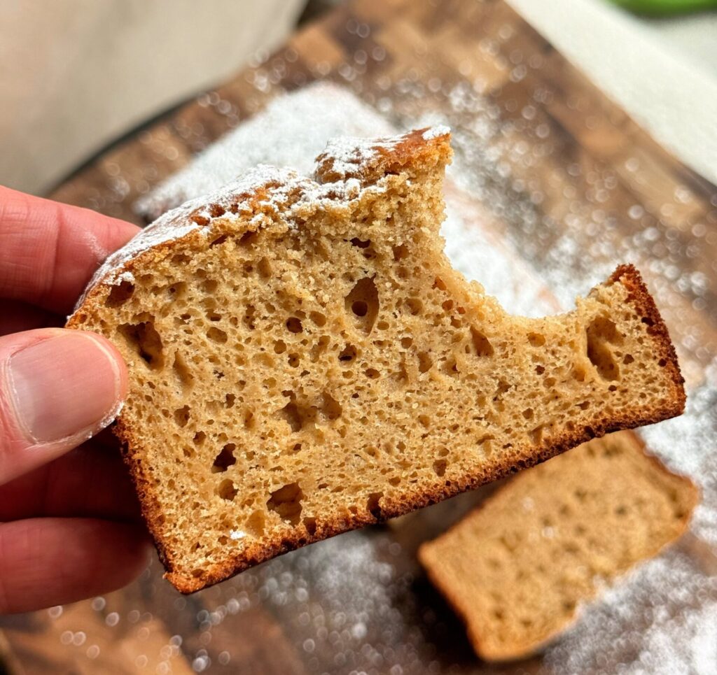 A golden brown cinnamon protein pound cake loaf made with applesauce.