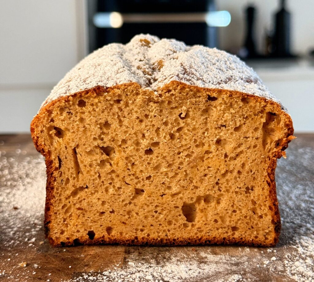 A golden brown cinnamon protein pound cake loaf made with applesauce.