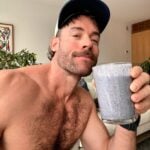 Jacob, founder of BakedLean, drinking a high fiber blueberry spinach shake