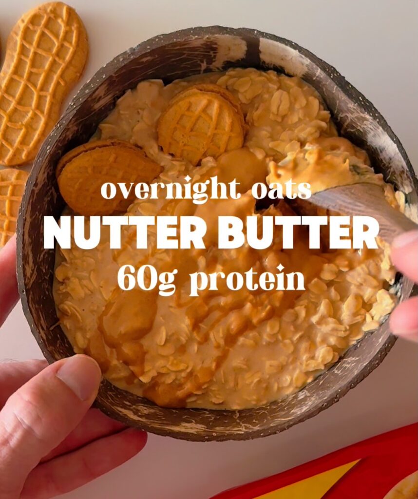 Finished bowl of Nutter Butter overnight oats topped with whole cookies, labeled with "60g protein."