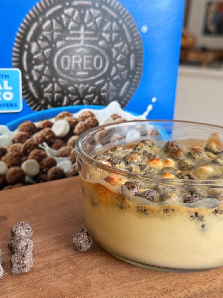 Oreo cheesecake with Oreo Puffs cereal box behind it for branding.