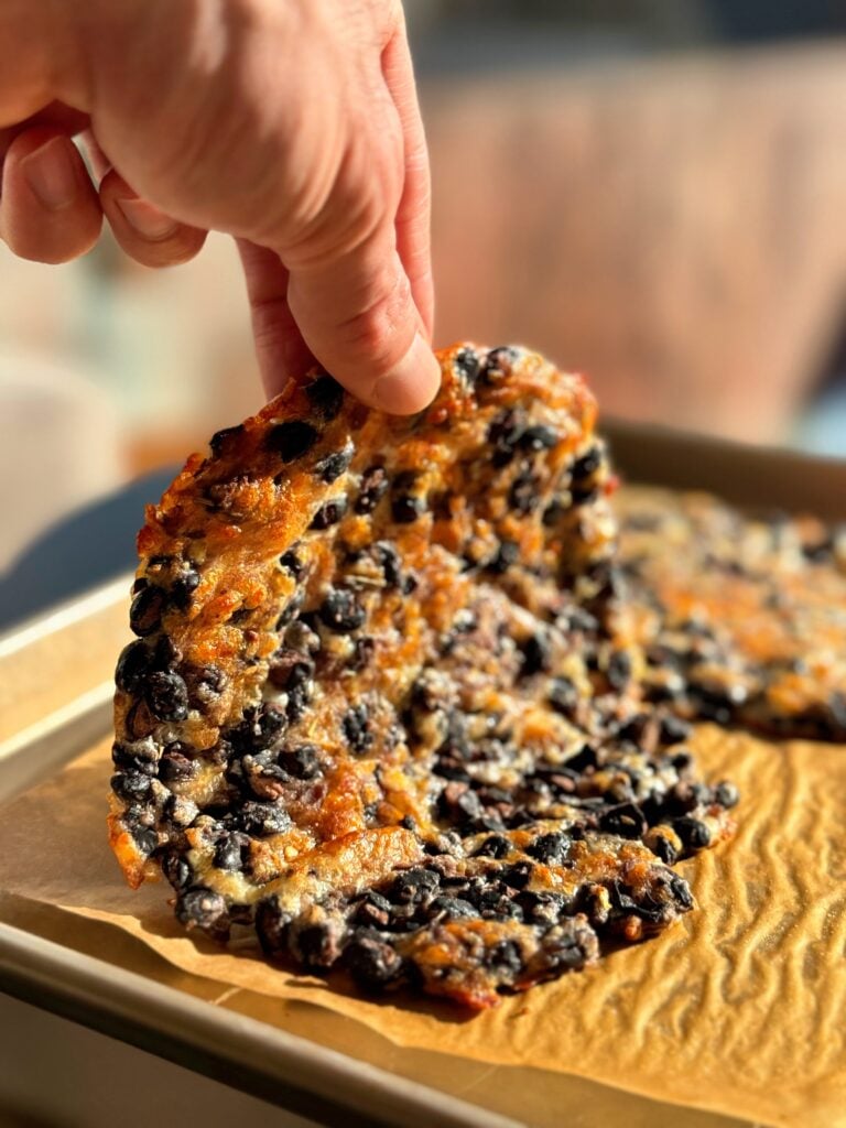 A platter of sliced bean and cheese wraps served with bowls of salsa and Greek yogurt "sour cream.