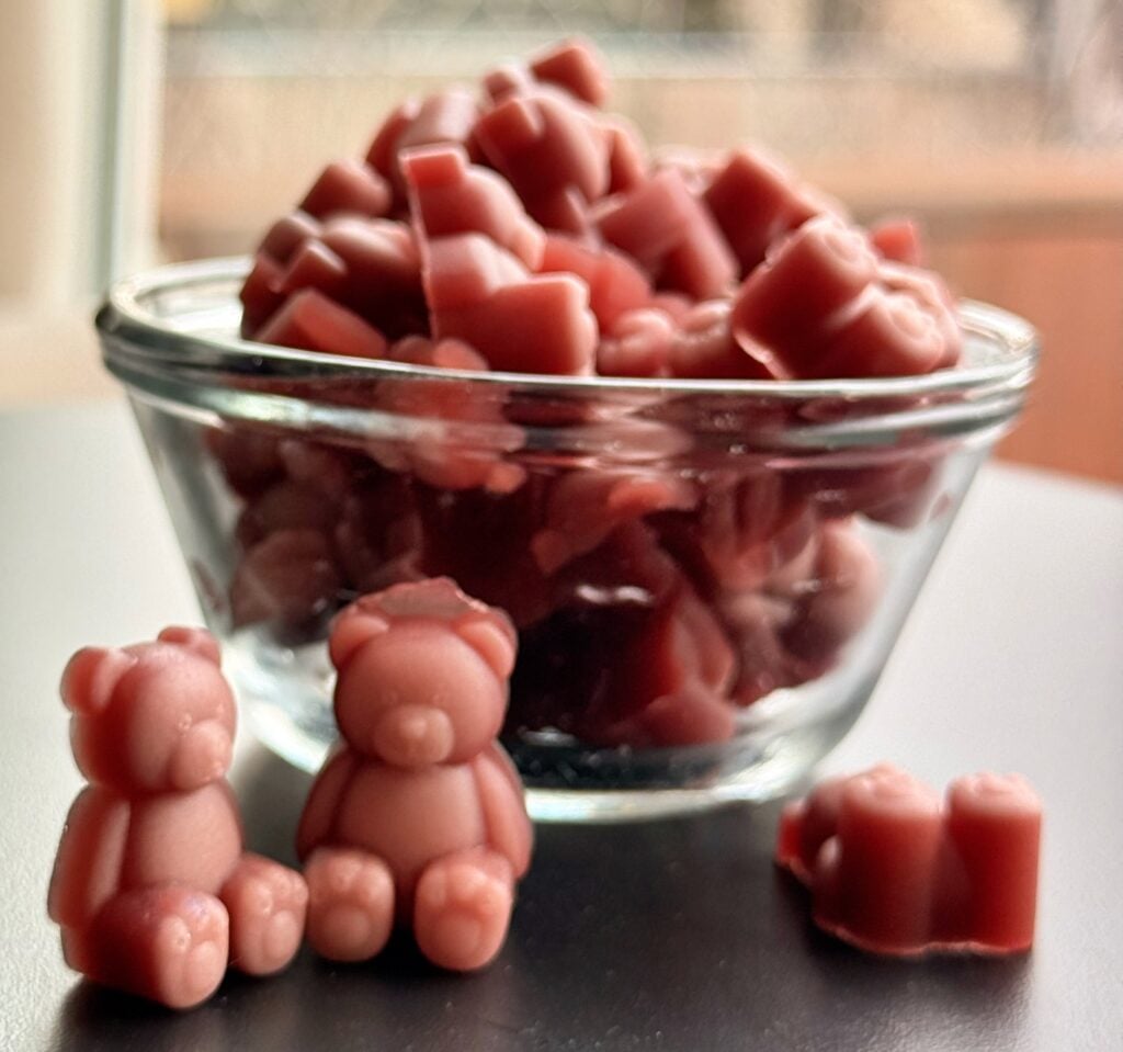 Homemade pomegranate creatine gummy bears in glass bowl