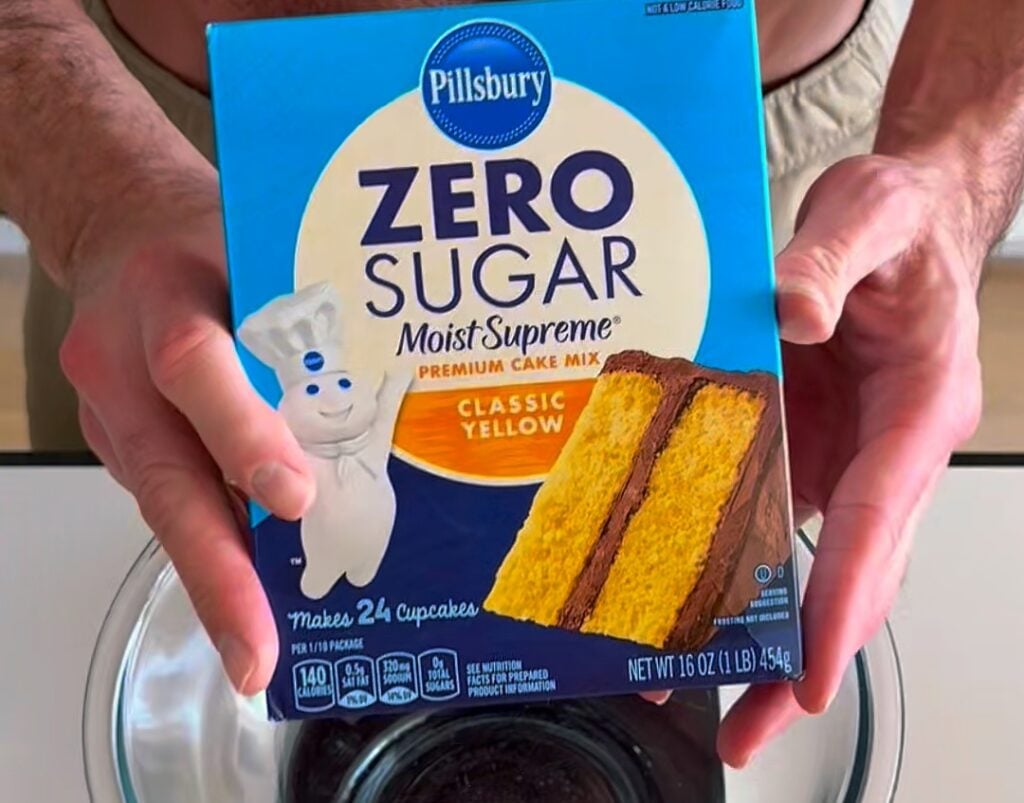 Greek yogurt and PE Science protein powder next to a box of cake mix.