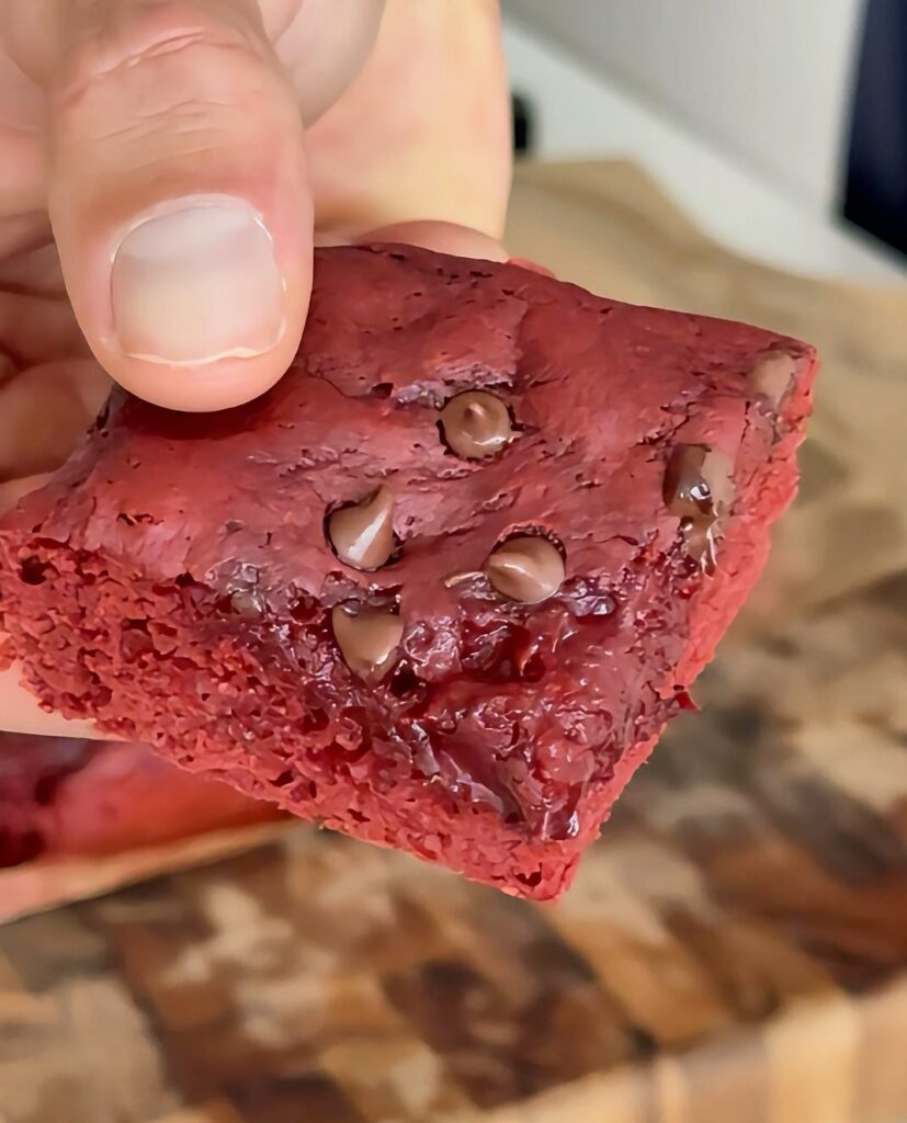 slice in hand red velvet protein brownie