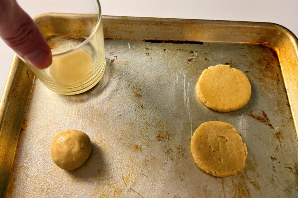 2-ingredient almond honey cookies being pressed
