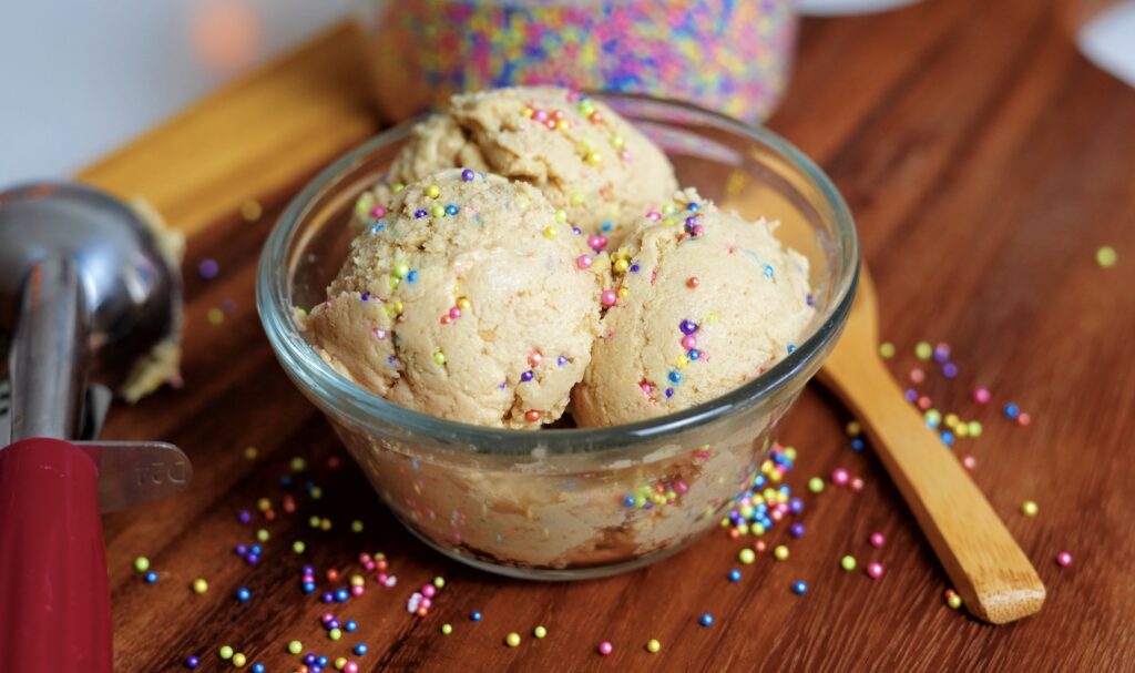 Rolled protein cookie dough bites on a plate.
