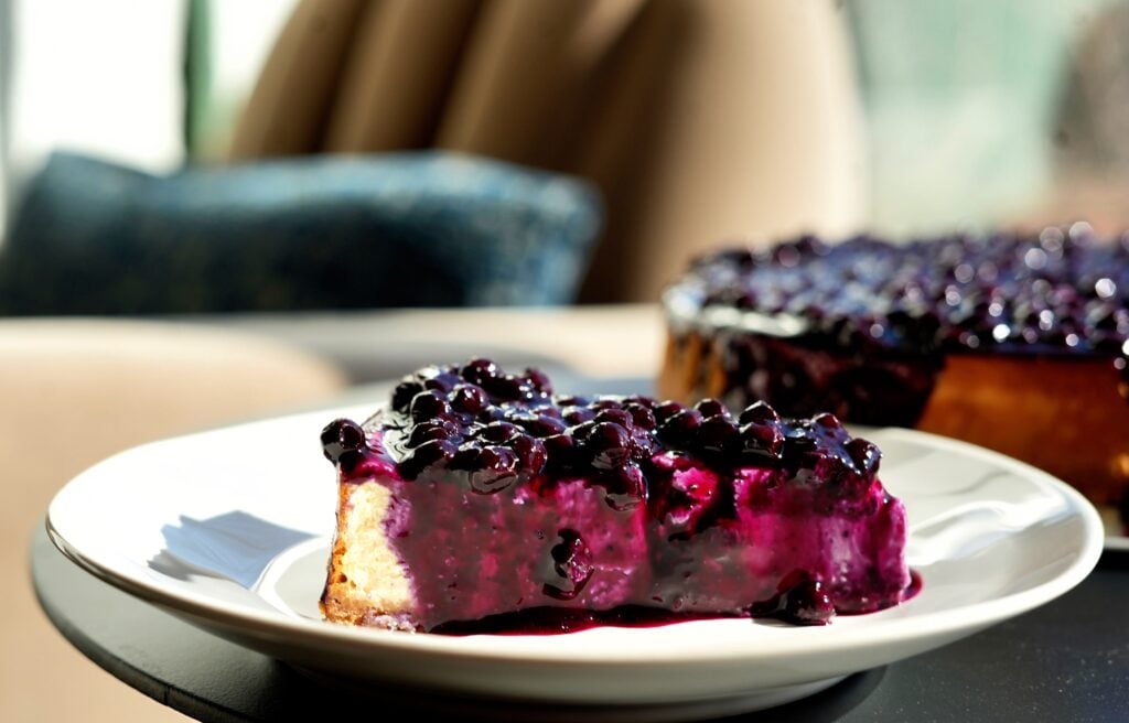 Slice of Angle shot of Overhead High-Protein Blueberry Keto Cheesecake