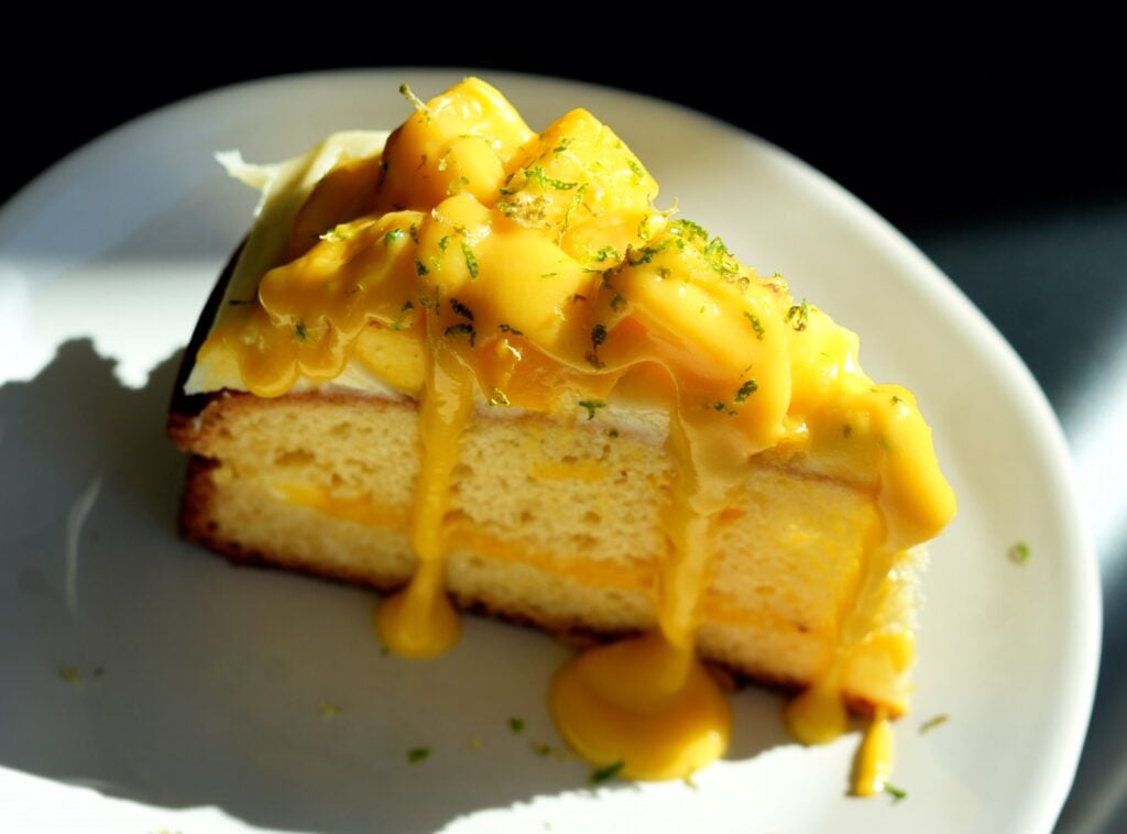 Sliced mango cake shot close up overhead