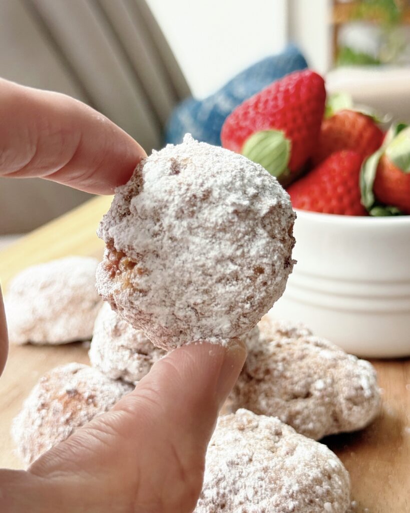 Tossing Donuts in Powdered Sugar