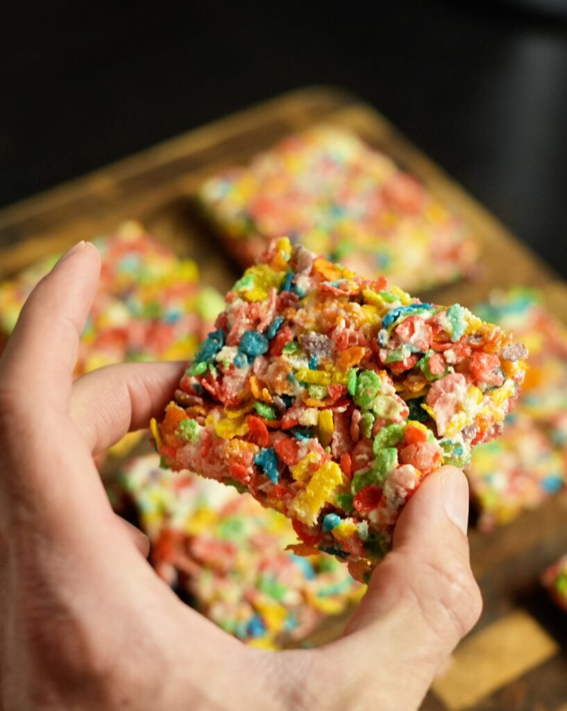 Protein Fruity Pebbles Rice Crispy Treats in hand close up